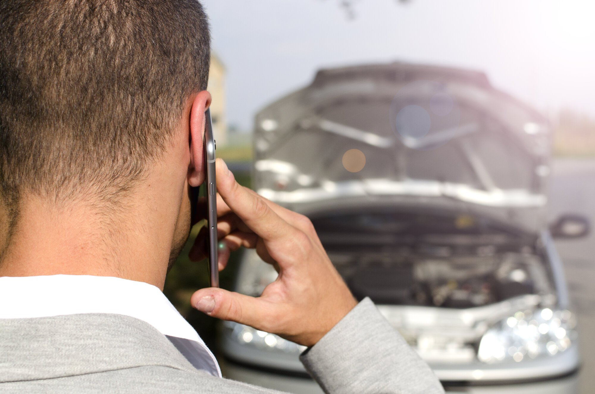 man-standing-by-broken-vehicle-calling-tow-service man-standing-by-broken-vehicle-calling-tow-service